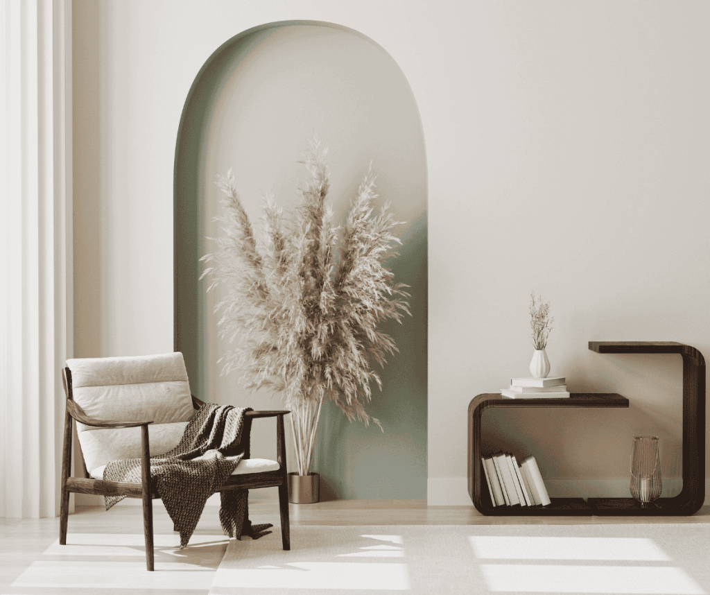 Interior painting of an olive green feature wall with a stylish chair, showcasing professional painting services for a flawless finish